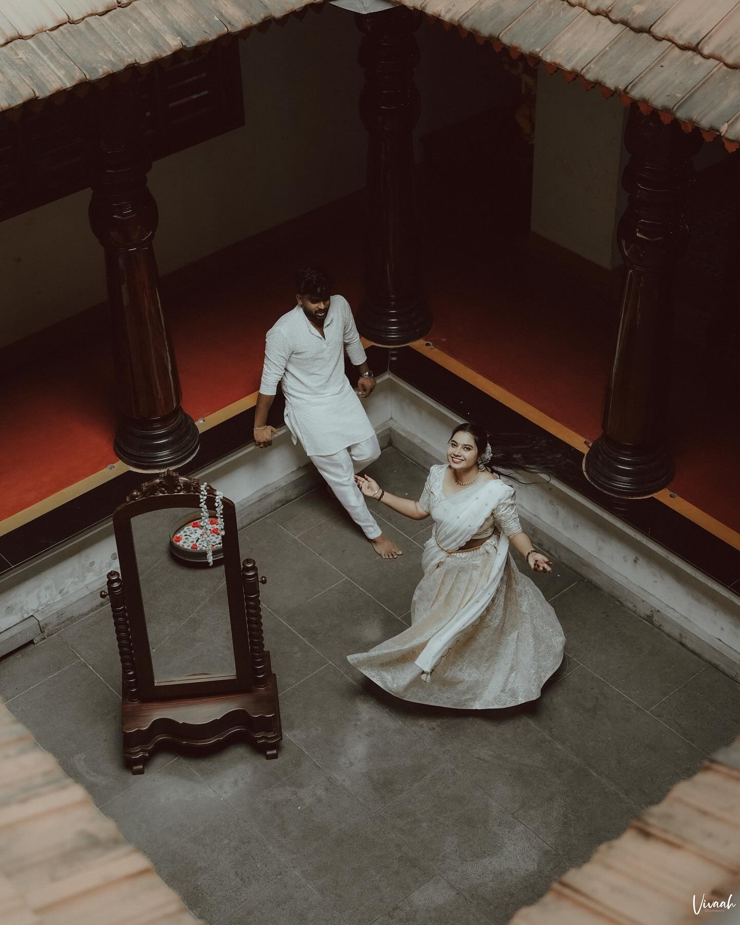 A couple sharing a quiet moment in a traditional courtyard